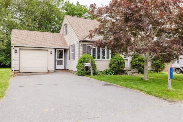 51 Jette St, Swansea, MA 02777 - view of front facade with asphalt driveway, a garage, a shingled roof, and a front yard