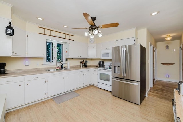 51 Jette St, Swansea, MA 02777 - kitchen with white appliances, a ceiling fan, white cabinets, light wood finished floors, and light countertops