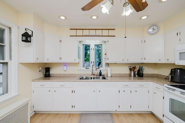 51 Jette St, Swansea, MA 02777 - kitchen featuring radiator, white appliances, a ceiling fan, white cabinetry, and crown molding