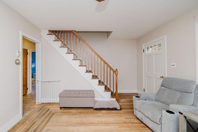 51 Jette St, Swansea, MA 02777 - living area with wood finished floors, stairs, and radiator