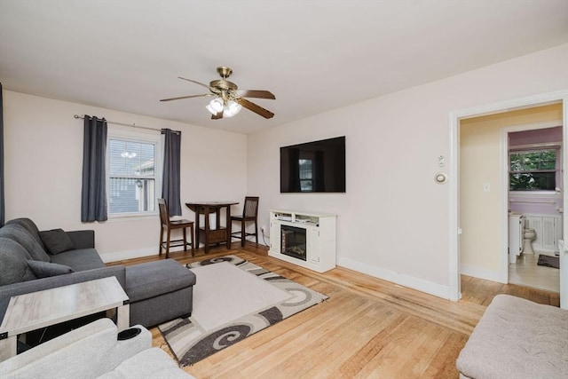51 Jette St, Swansea, MA 02777 - living area featuring light wood-style flooring, ceiling fan, and a glass covered fireplace