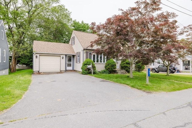 51 Jette St, Swansea, MA 02777 - view of front of house featuring a garage, asphalt driveway, a front yard, and roof with shingles