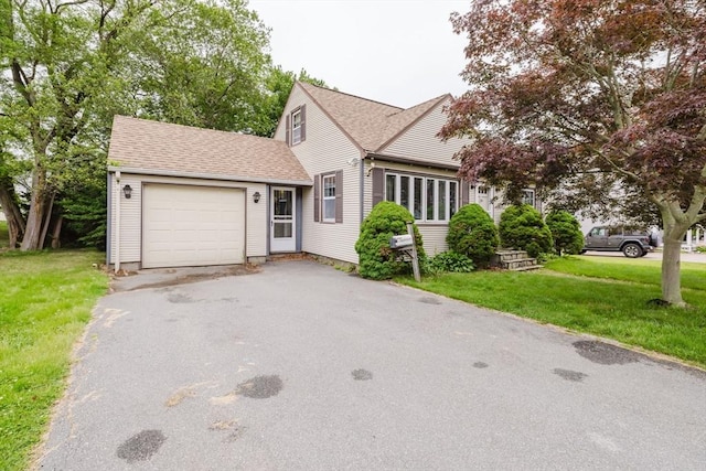 51 Jette St, Swansea, MA 02777 - view of front of house with driveway, a garage, a front yard, and a shingled roof