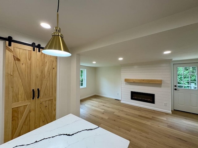5 Mechanic St, Brookfield, MA 01506 - unfurnished living room with wood finished floors, healthy amount of natural light, recessed lighting, a fireplace, and baseboards