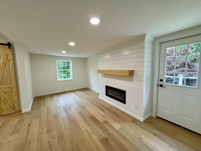 5 Mechanic St, Brookfield, MA 01506 - unfurnished living room featuring a barn door, light wood finished floors, recessed lighting, baseboards, and a fireplace