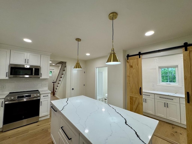 5 Mechanic St, Brookfield, MA 01506 - kitchen featuring stainless steel appliances, a barn door, tasteful backsplash, white cabinetry, and recessed lighting