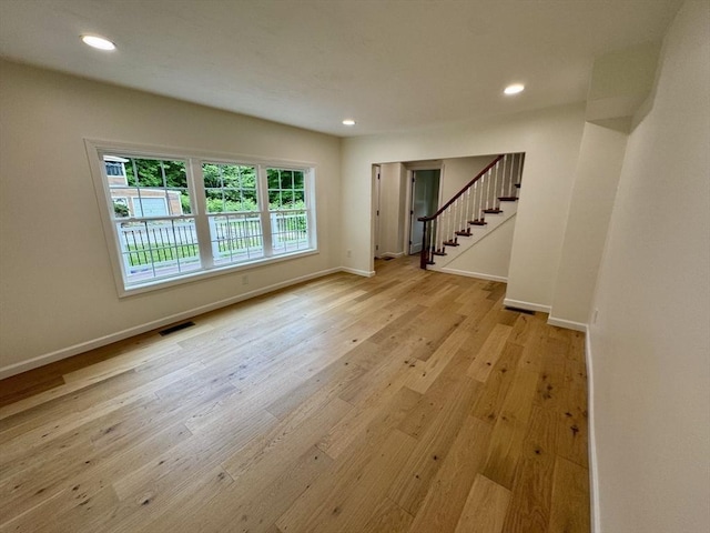 5 Mechanic St, Brookfield, MA 01506 - unfurnished living room with baseboards, stairway, wood finished floors, and recessed lighting