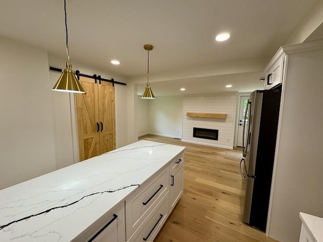 5 Mechanic St, Brookfield, MA 01506 - kitchen with freestanding refrigerator, white cabinets, recessed lighting, light stone counters, and hanging light fixtures