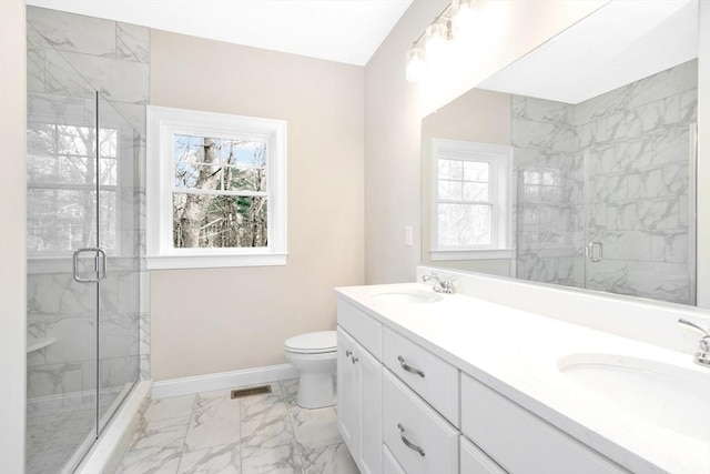 bathroom featuring vanity, toilet, and walk in shower