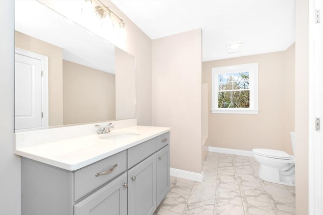 bathroom featuring vanity and toilet