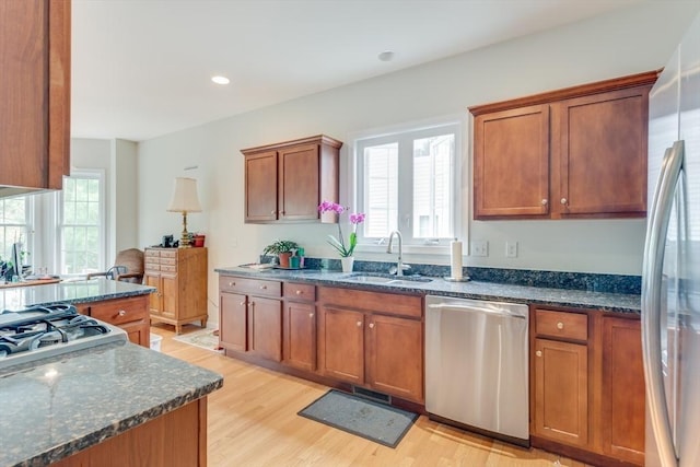 28 Picket Fence, Plymouth, MA 02360 - kitchen with stainless steel appliances, a sink, light wood-style floors, brown cabinets, and dark stone countertops