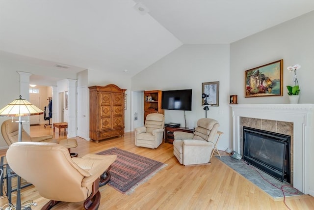 28 Picket Fence, Plymouth, MA 02360 - living area featuring lofted ceiling, ornate columns, light wood-style flooring, and a tile fireplace