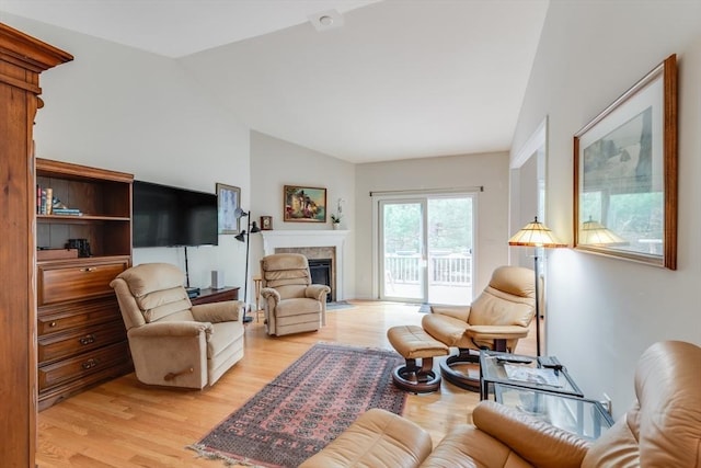 28 Picket Fence, Plymouth, MA 02360 - living room featuring lofted ceiling, light wood-type flooring, and a fireplace with flush hearth