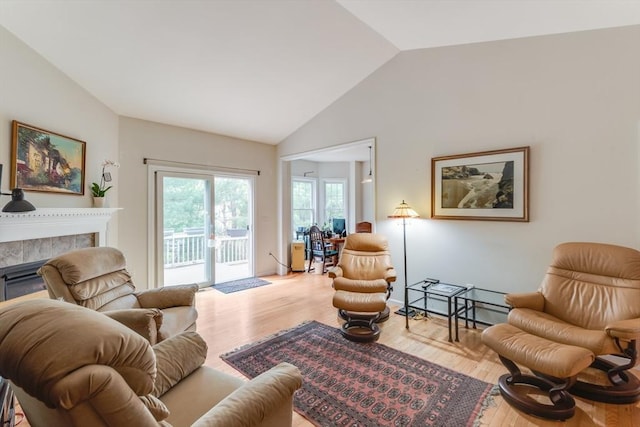 28 Picket Fence, Plymouth, MA 02360 - living room featuring lofted ceiling, wood finished floors, and a tiled fireplace