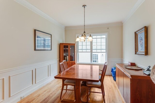 28 Picket Fence, Plymouth, MA 02360 - dining space featuring a chandelier, light wood-type flooring, ornamental molding, wainscoting, and a decorative wall