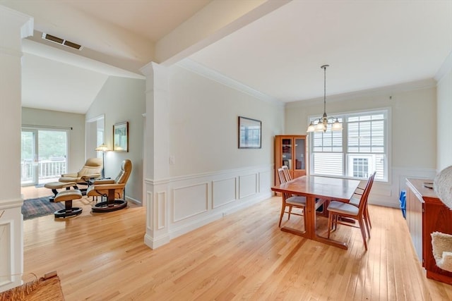 28 Picket Fence, Plymouth, MA 02360 - dining area featuring light wood-type flooring, wainscoting, a chandelier, a decorative wall, and ornamental molding