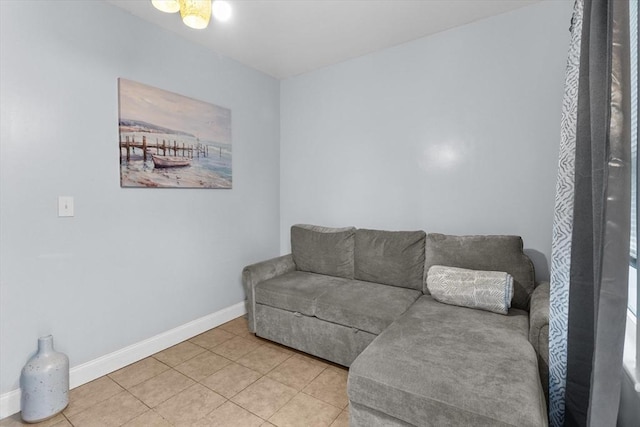 living room featuring light tile patterned floors and baseboards