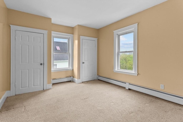 unfurnished bedroom with a baseboard radiator, carpet flooring, and baseboards