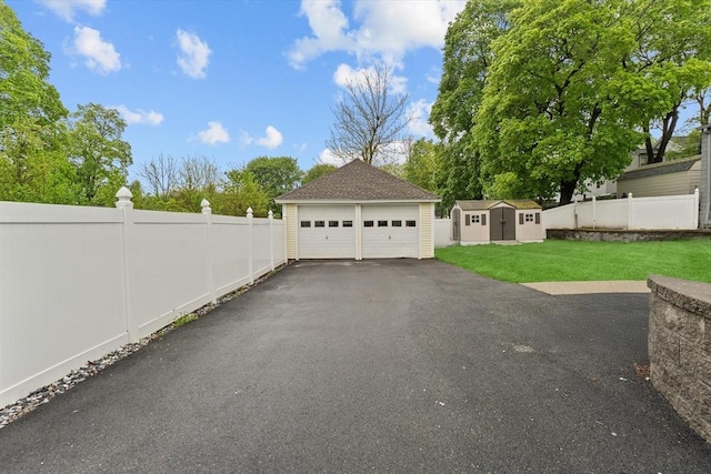 detached garage with a storage shed