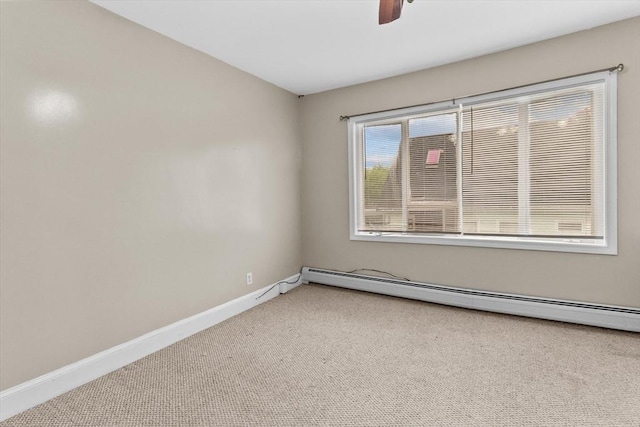 empty room featuring carpet, a baseboard radiator, ceiling fan, and baseboards