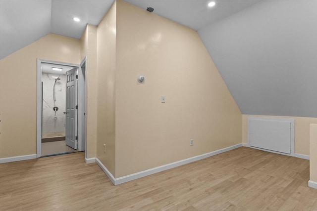 additional living space with vaulted ceiling, baseboards, light wood-style flooring, and recessed lighting