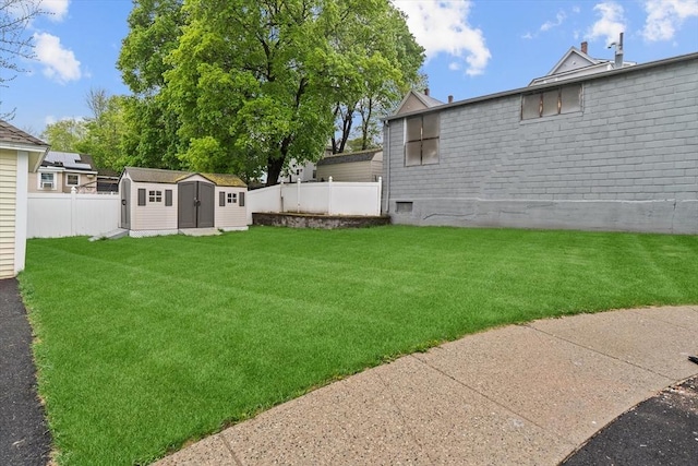 view of yard featuring a storage shed and an outbuilding