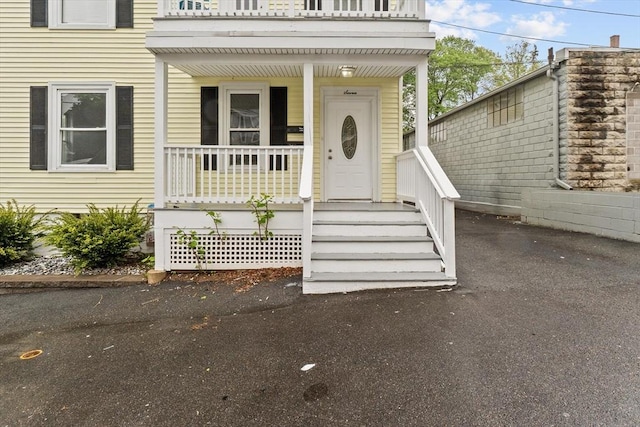 view of exterior entry with covered porch