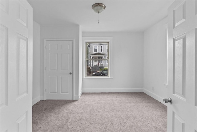 unfurnished bedroom featuring carpet floors and baseboards