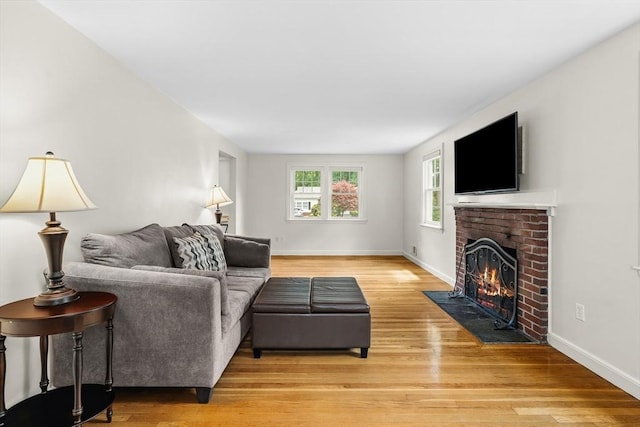 8 Knight Rd, Framingham, MA 01701 - living area featuring light wood finished floors, a brick fireplace, and baseboards