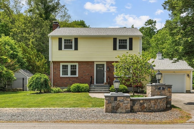 8 Knight Rd, Framingham, MA 01701 - colonial-style house with a chimney, concrete driveway, an attached garage, a front yard, and brick siding