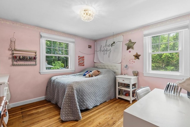 8 Knight Rd, Framingham, MA 01701 - bedroom with multiple windows, light wood-type flooring, and baseboards