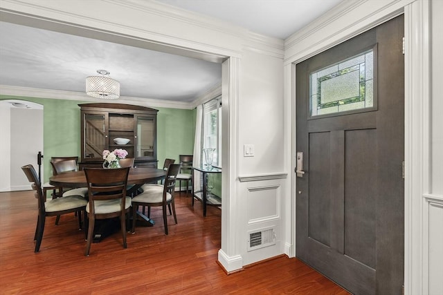 8 Knight Rd, Framingham, MA 01701 - entryway with wood finished floors, crown molding, arched walkways, and a decorative wall