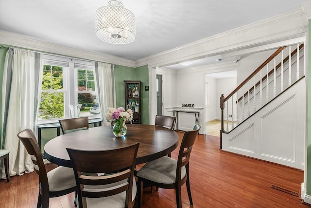 8 Knight Rd, Framingham, MA 01701 - dining room with a chandelier, wood finished floors, stairway, and ornamental molding