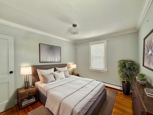 bedroom featuring a baseboard heating unit, ornamental molding, and wood finished floors