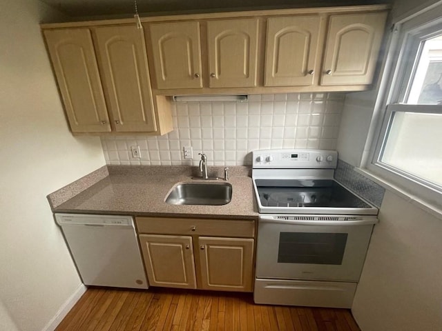 kitchen featuring electric range, dishwasher, sink, backsplash, and hardwood / wood-style floors