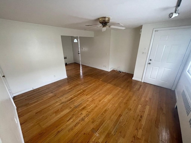 spare room with hardwood / wood-style flooring and ceiling fan