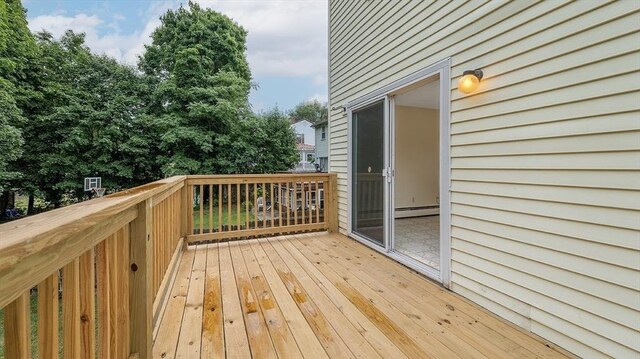 wooden deck featuring a baseboard heating unit