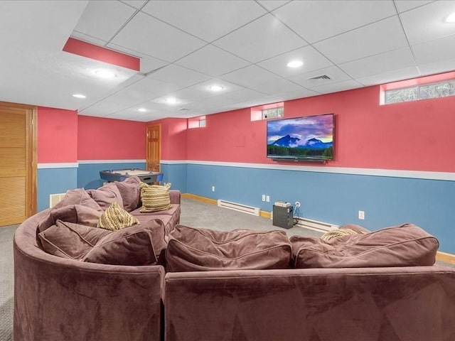 carpeted cinema featuring a baseboard heating unit and visible vents