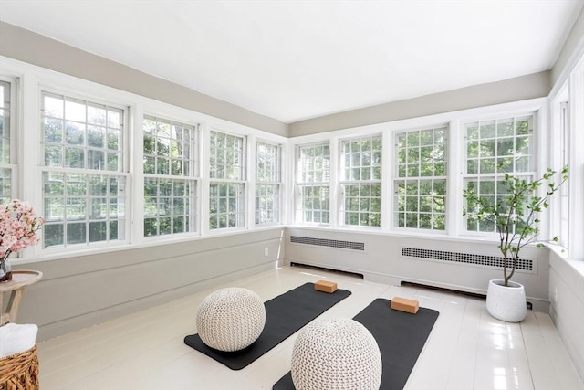 sunroom / solarium featuring radiator heating unit