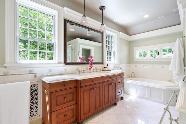 full bath featuring tile patterned floors, vanity, tile walls, and a garden tub