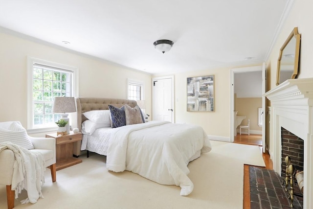 bedroom with multiple windows, a fireplace with flush hearth, baseboards, and a closet