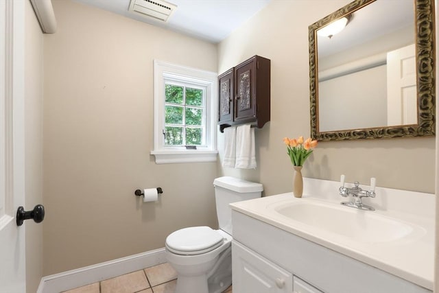 bathroom featuring visible vents, toilet, tile patterned flooring, baseboards, and vanity