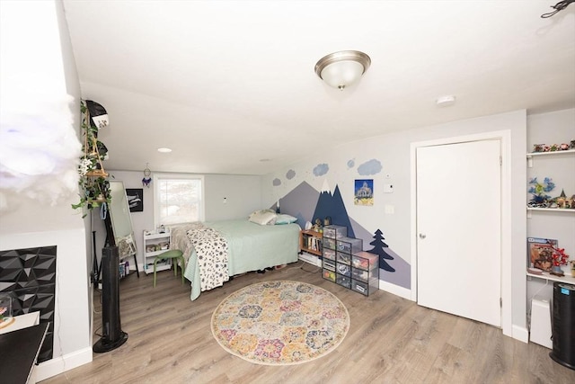 bedroom featuring baseboards and wood finished floors