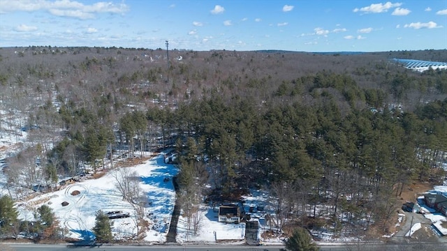 birds eye view of property featuring a wooded view