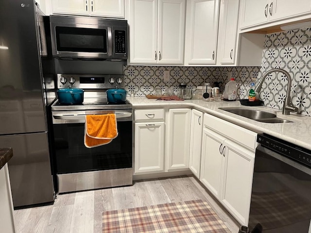 610 S Franklin St Unit F301, Holbrook, MA 02343 - kitchen featuring stainless steel appliances, light countertops, and white cabinets