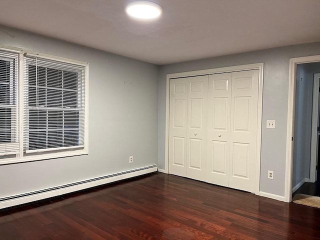 610 S Franklin St Unit F301, Holbrook, MA 02343 - unfurnished bedroom with baseboard heating, dark wood finished floors, and a closet
