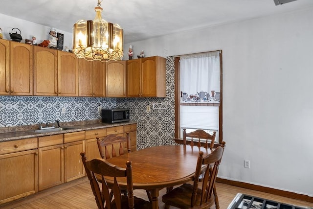 dining room featuring light wood-style floors and a chandelier