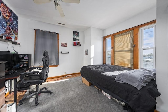 bedroom with a desk, a ceiling fan, and baseboards