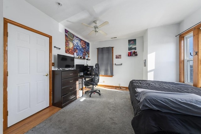 bedroom featuring a desk, wood finished floors, and ceiling fan