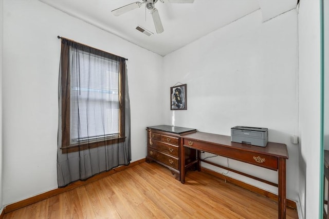 office with light wood-style floors, a ceiling fan, and baseboards